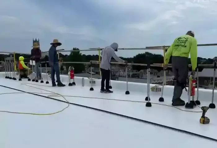 H.Kulak & Son contractors working on white commercial rooftop in Connecticut